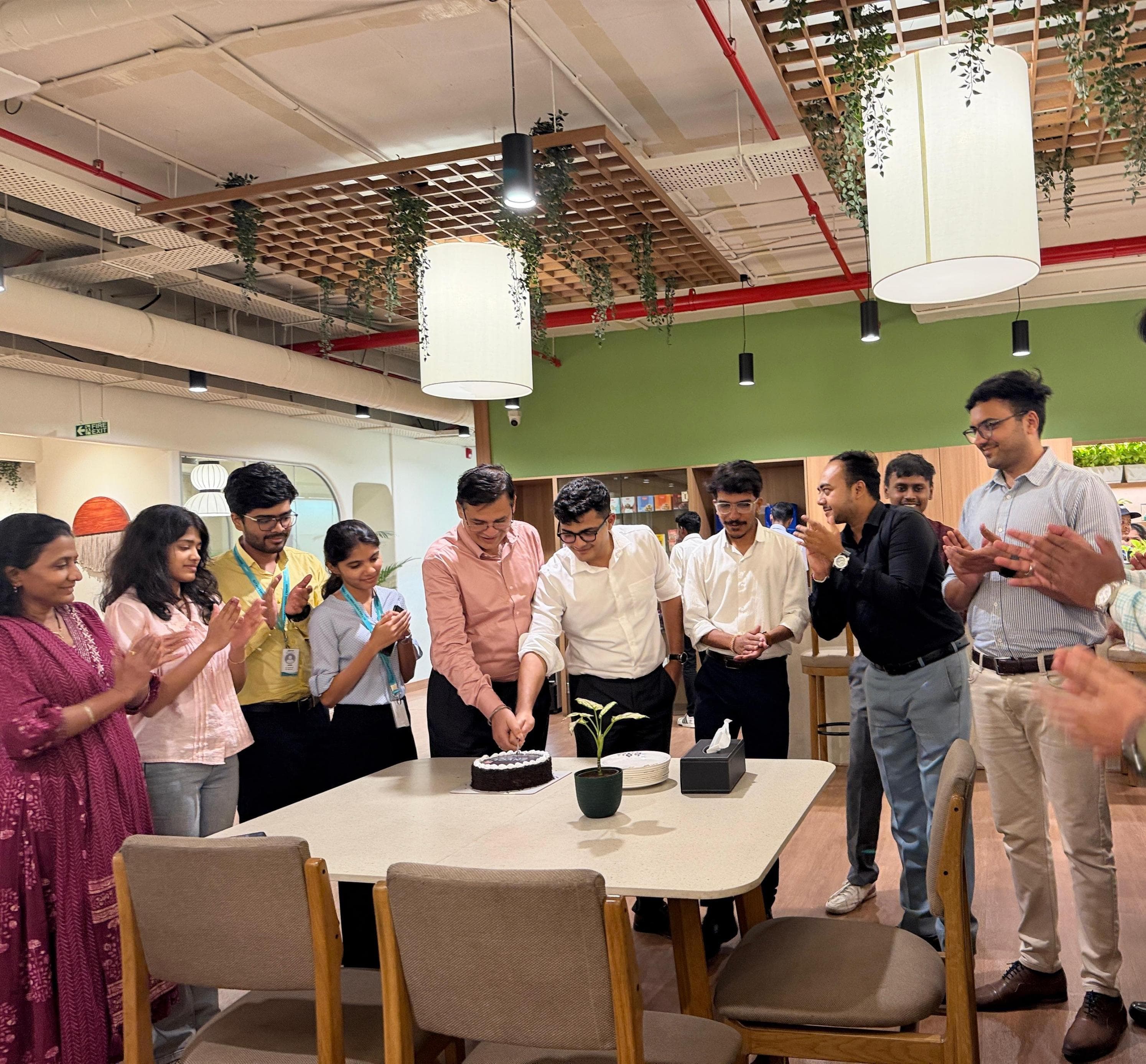 Xenvolt team cutting a celebration cake at the office